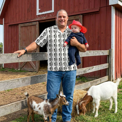 "Frankenstein Head" men’s Hawaiian shirt with gothic horror creature graphic in monster aloha pattern; front view; on model with baby and goats in front of red barn.
