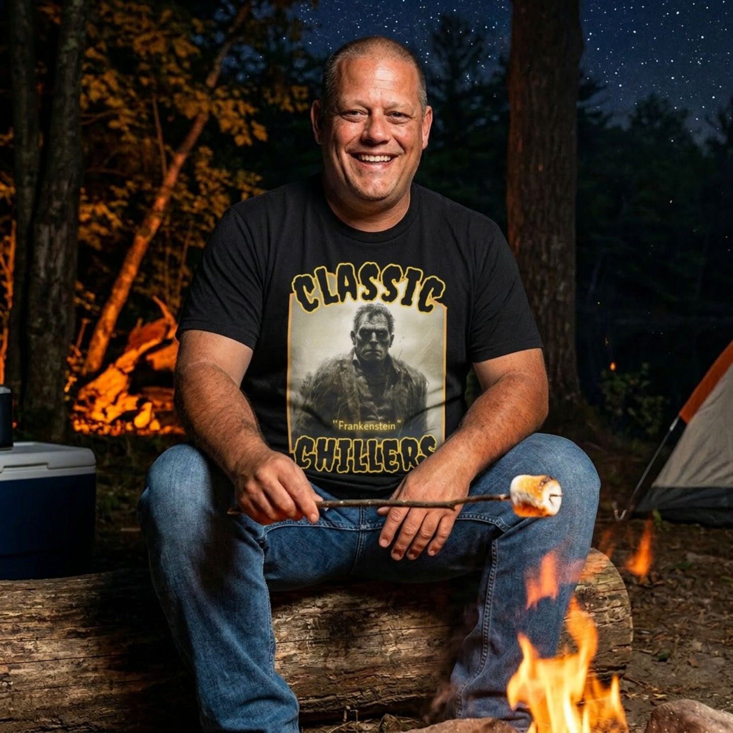 "Frankenstein" black t-shirt with gothic horror monster graphic and classic chillers logo; front view; on model roasting a marshmallow over a campfire at night.
