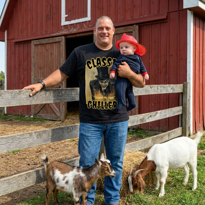 "Sinister Mr Hyde" black t-shirt with gothic man of murder graphic and classic chillers logo; front view; on model with baby and goats in front of red barn.
