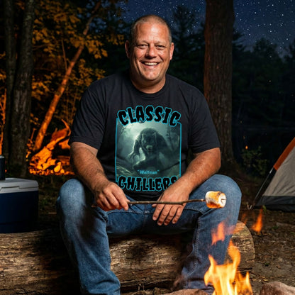 "Wolfman" black t-shirt with werewolf in the mist graphic and classic chillers logo; front view; on model roasting a marshmallow over a campfire at night.