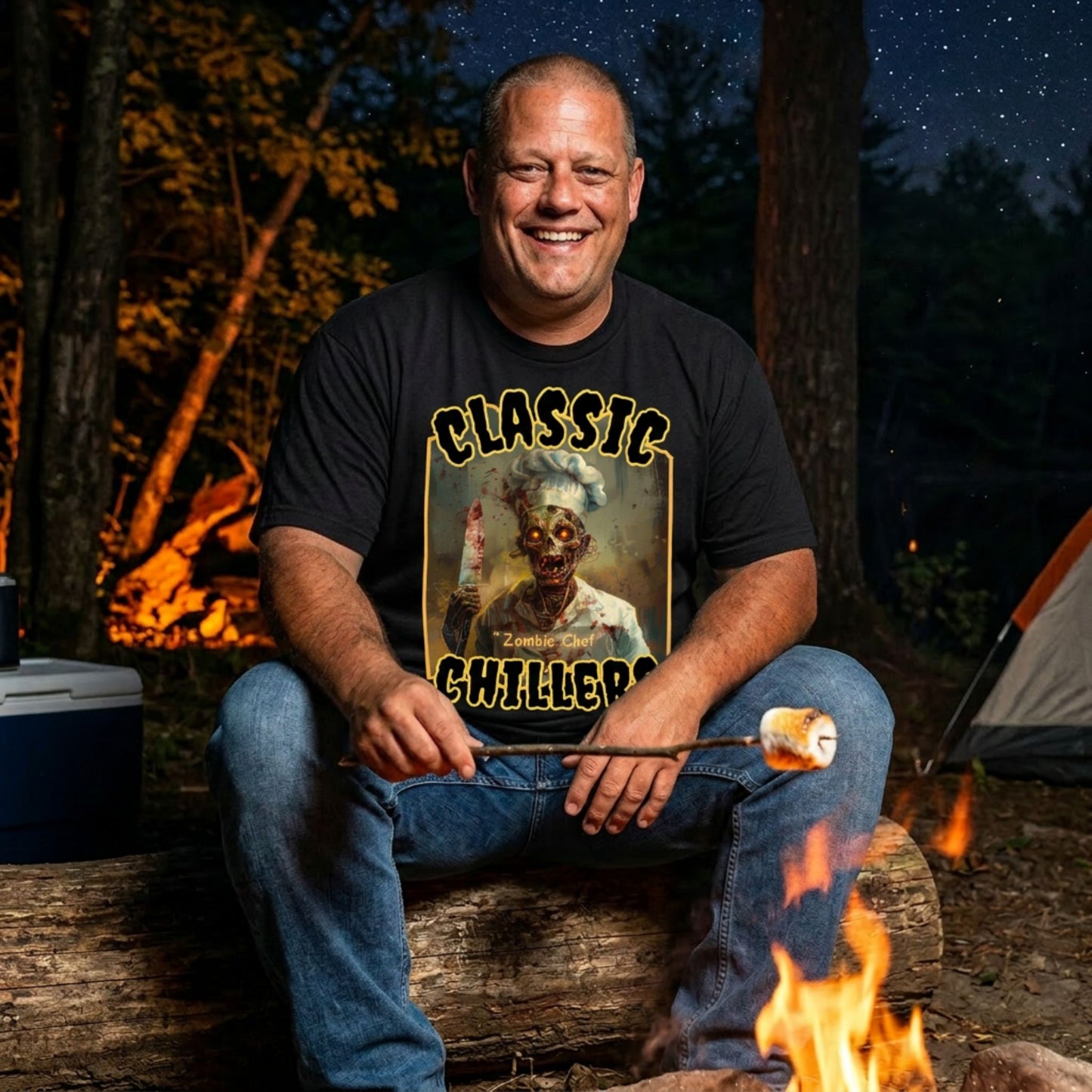 "Zombie Chef" black t-shirt with cannibal gourmet graphic and classic chillers logo; front view; on model roasting a marshmallow over a campfire at night.
